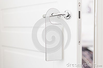 Door knob with empty label on a door handle for your text. Empty white flyer mockup hang on door handle. Leaflet design Stock Photo