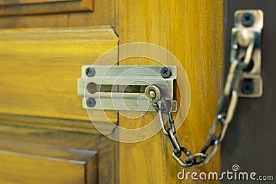 Door lock, chain lock on wooden door Stock Photo