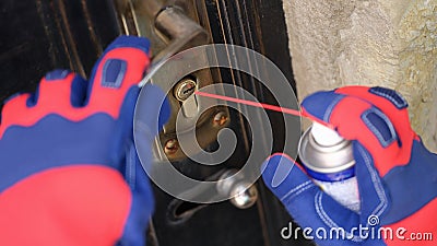 Door lock and handyman hands with spray balloon close up. Stock Photo