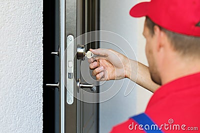 door lock service - locksmith working Stock Photo