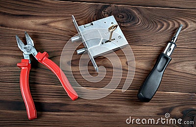 Door lock and tools on a wooden surface Stock Photo