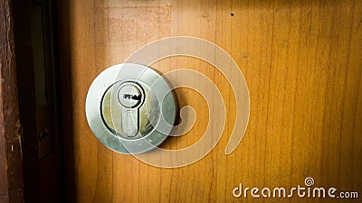 A door lock with wooden door and metal locks Stock Photo