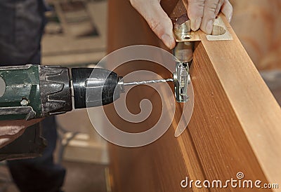 Door mounting, install deadbolt lock, electric drill drilled hole, close-up. Stock Photo