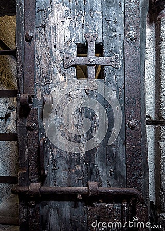 Door in old prison closeup. Inside dark medieval prison Stock Photo