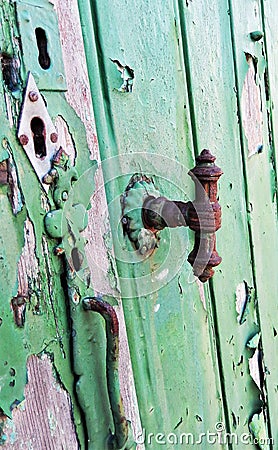 Multiple keyholes and a rusty vintage door handle closeup Stock Photo