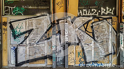 The door painted in color graffiti drawing white aerosol paints in style of street art culture Editorial Stock Photo