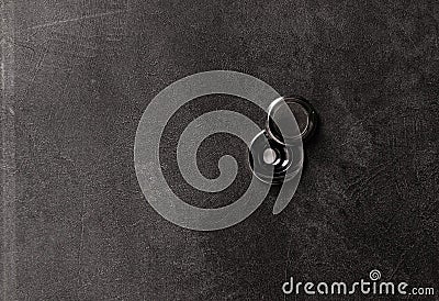 Door peephole on a dark gray metal door. Stock Photo