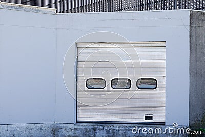 Door roller silver facade industrial unit warehouse building entrance delivery Stock Photo