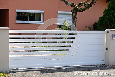 Door stainless white steel garden gate front of suburb family home Stock Photo