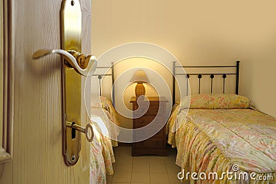 door to bright room open, two old-fashioned iron beds filled, Serene Sleeping in Twin Beds, room on sunny morning, Start your day Stock Photo