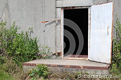 The door to a formerly used ammunition and explosives bunker. Editorial Stock Photo