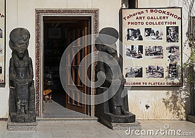 Door to the Taharqa 1 Bookshop flanked by statues of the Egyptian God of War, Maahes. Editorial Stock Photo