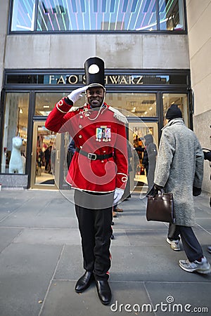 A doorman dressed as a toy soldier stands outside newly reopened the FAO Schwarz flagship store at Rockefeller Plaza Editorial Stock Photo