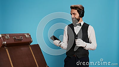 Doorman texting and drinking coffee Stock Photo