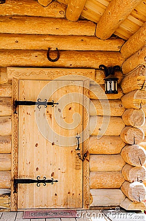 Doors with wrought iron hinges in the wooden house. Editorial Stock Photo