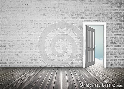 Doorway opening to blue sky in grey brick wall room Stock Photo