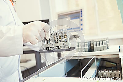 Dope test. biochemical medical laboratory. Hand with test near analyzer Stock Photo