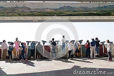 Dora Observatory, DMZ, South Korea - September 8 2017: Tourists watching with binoculars to North Korean village Propaganda villag Editorial Stock Photo