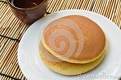 Dorayaki Japanese pancake stuffed sweet mashed bean on plate eat with tea cup Stock Photo