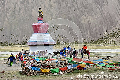 Dorchen, Tibet, China, June, 18, 2018. Pilgrims near the white Buddhist stupa at the beginning of the Cora around Kailas Editorial Stock Photo