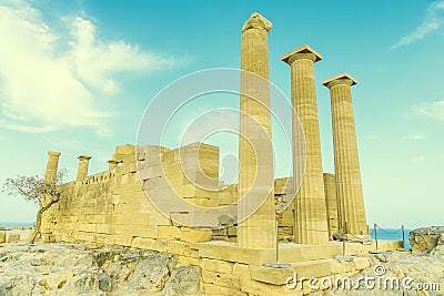 Doric temple of Athena Lindia on Acropolis of Lindos Rhodes, Greece. Front view of columns and walls. near tree grows Stock Photo