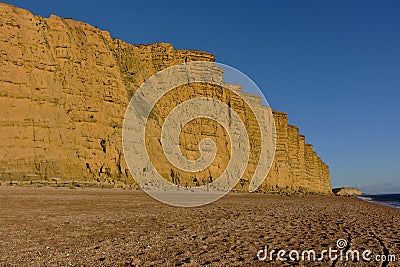 Dorset cliffs, sunset on the beach, sea and sky. Stock Photo