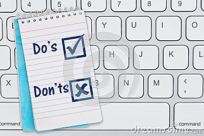 Dos and Donts message blue notepad on gray keyboard Stock Photo