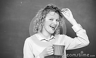 Dose of caffeine. Teacher drink coffee chalkboard background. Woman enjoy coffee. Energy charge for whole day. Inspiring Stock Photo