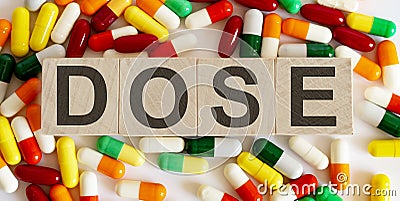 DOSE medicine words on the wooden block.Healthcare conceptual Stock Photo