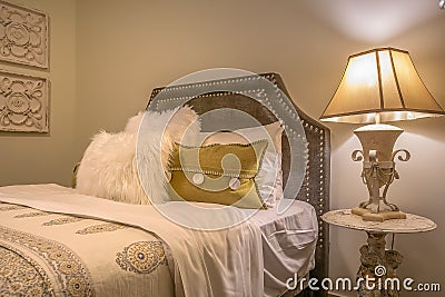 Double bed with fluffy pillows against the upholstered belgrave headboard Stock Photo