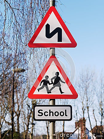 Double bend first to left sign and School children crossing sign Stock Photo