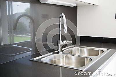 A double bowl stainless steel kitchen sink in a modern design Stock Photo