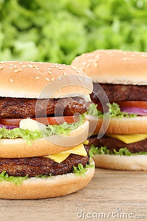 Double burger hamburger closeup close up beef tomatoes lettuce c Stock Photo