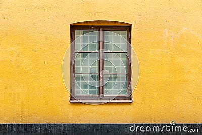 Double casement window on yellow concrete wall Stock Photo