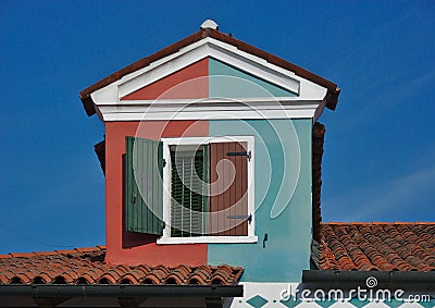 Double-colored mansard roof dormer in Burano, Italy Stock Photo