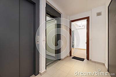 Double elevators on a landing of a residential apartment building with stoneware floors Stock Photo