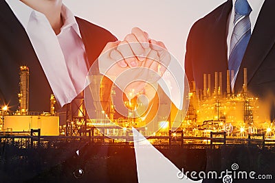 double exposure of arm wrestling between businessman and businesswoman with oil refinery plant background Stock Photo