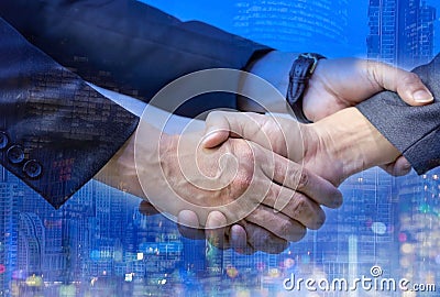 Double exposure of Business people trust of Hands shake young people show of strength teamwork in the city Stock Photo