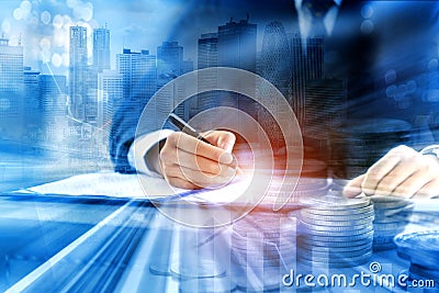 Double exposure of business person signing contract document or concluding agreement with coins money and immovable property Stock Photo