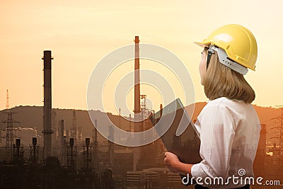 Double exposure of business woman with oil refinery background Stock Photo