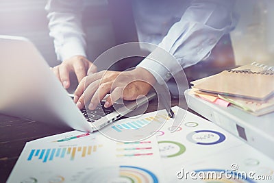 Double exposure of businessman hand working laptop on wooden desk in office in morning light. The concept of modern work Stock Photo