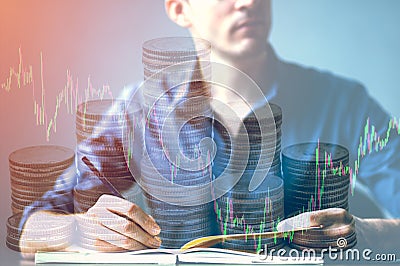 Double exposure of businessman writhing on desk and stock market or forex graph and stack coin suitable for financial Stock Photo