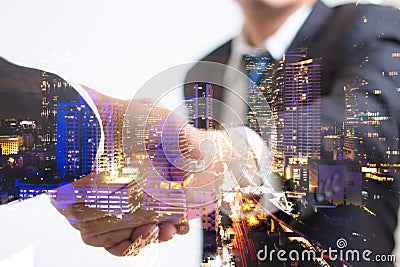 Double exposure concept. Investor business handshake with city night. Businessman shaking hands Stock Photo