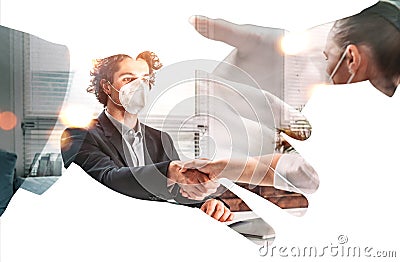 Double exposure of handshake of two business people in formal wear, recruitment process. Face protective mask. Office background. Stock Photo