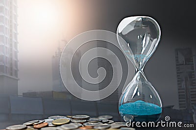 Double exposure of hourglass with coins for time of business Stock Photo