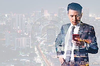 The double exposure image of the businessman using a smartphone and overlay with cityscape image. the concept of 5G, smartphones, Stock Photo