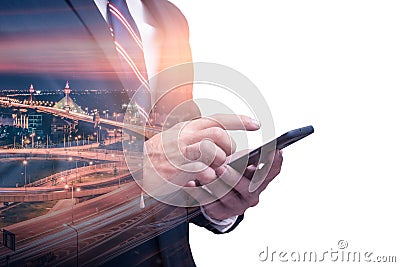 The double exposure image of the businessman using a smartphone during sunrise overlay with cityscape image. The concept of modern Stock Photo