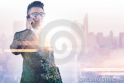 The double exposure image of the businessman using a smartphone during sunrise overlay with nature image. Stock Photo