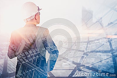 The double exposure image of the engineer standing back during sunrise overlay with cityscape image. The concept of engineering, c Stock Photo