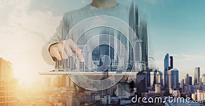 Double exposure, a man using digital tablet, and modern buildings hologram. Real estate business and building technology concept Stock Photo